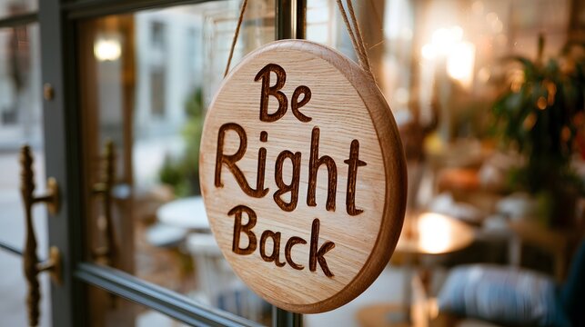 Be right back hanging sign on shop glass door