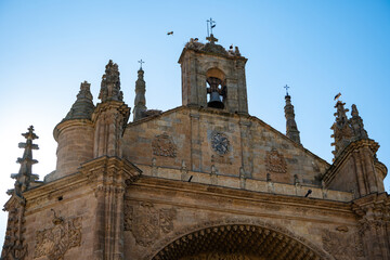 Fototapeta premium White Stork Ciconia Ciconia Nesting on the Historic Stone Bell Gable of a Church Roof in Salamanca Spain