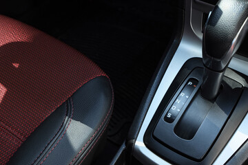 Obraz premium close-up of automatic car gear shift and red car seat