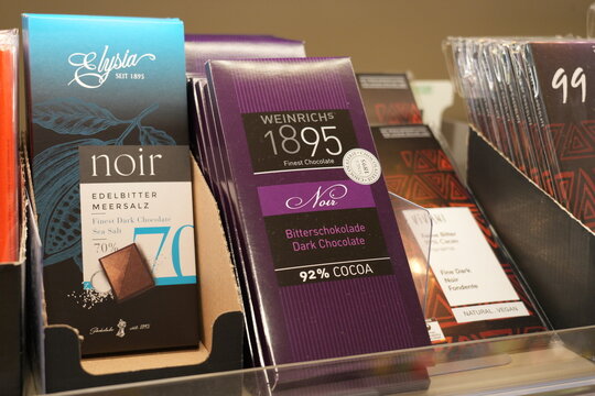 Assorted dark chocolate bars displayed on a store shelf.
