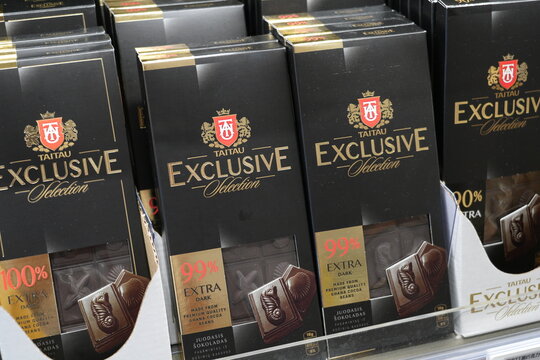 Premium high percentage dark chocolate bars on a store shelf.