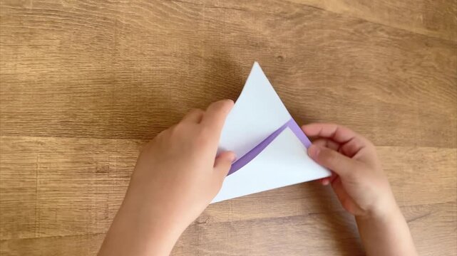 Child Folds Light Purple Origami Paper, Sixth Step in a Series, 4K