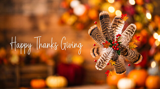 Thanksgiving festive decoration with turkey feathers, autumn leaves, and berries on a blurred wooden background