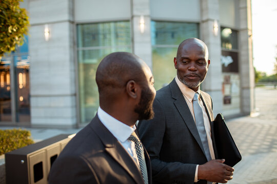 Two business colleagues talking outside office building