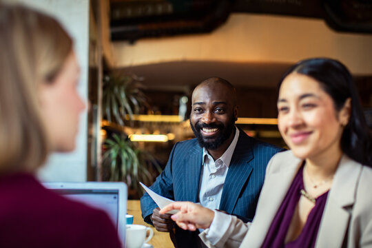 Smiling businessman in job interview at cafe