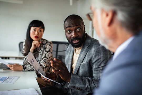 Diverse business team discussing reports in office