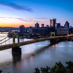 Obraz premium Golden hour cityscape with modern bridge and skyline.