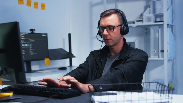 Male IT Support Agent Providing Professional Assistance to a Customer During a Live Support, Support Specialist Providing IT Assistance and Problem Solving Through Live Communication with headset.