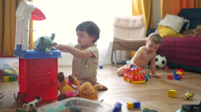 baby group plays in toy kitchen. baby plays and hits a toy with a car bus. happy family kid dream concept. baby lifestyle feeds toys in the kitchen plays cook