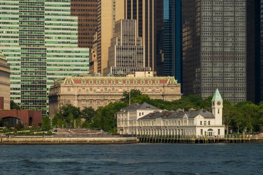New York, NY - US - Jul 1, 2026 The Alexander Hamilton U.S. Custom House and Pier A Harbor House stand prominently at the southern tip of Manhattan against a backdrop of modern glass skyscrapers.