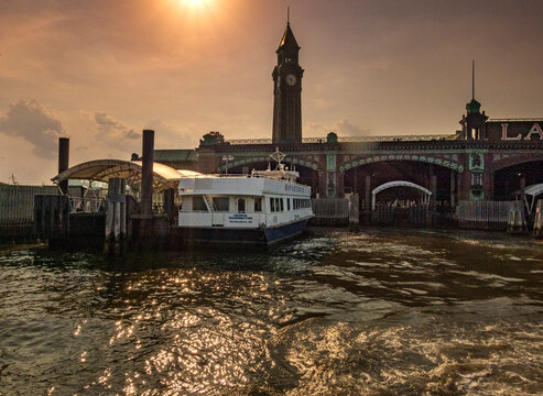 Hoboken, NJ - US - Jul 1, 2026 The historic Hoboken Ferry Terminal stands as a grand Beaux-Arts gateway, its iconic clock tower and copper-clad arches welcoming commuters across the Hudson River