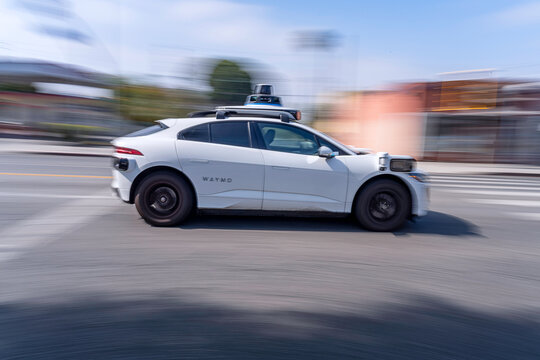 Los Angeles, CA, USA: June 25, 2025: A Waymo autonomous taxi drives down Santa Monica boulevard in Los Angeles, CA.