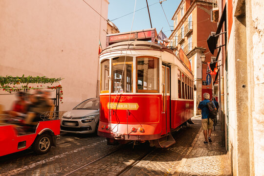 Lisbon, Portugal - July20, 2023: Red tram on narrow street