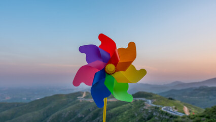 Toy windmill wind pinwheel in the wind turbine at sunset © 路阳