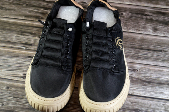 Cairo, Egypt, July 3 2026: a pair of men's breathable casual sneakers feature a black fabric upper and a contrasting rubber sole, men's shoes