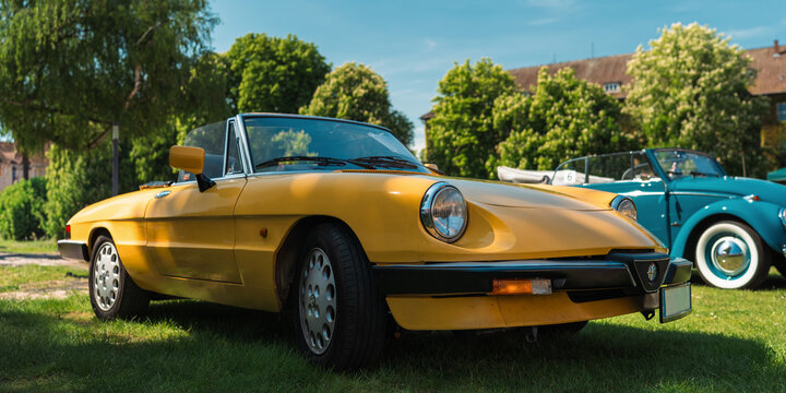 Berlin, Germany - May 3, 2026. Yellow Alfa Romeo classic roadster at oldtimer show.