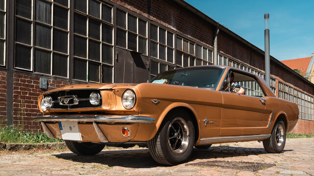 Berlin, Germany - May 3, 2026. Gold Ford Mustang classic coupe in Berlin.