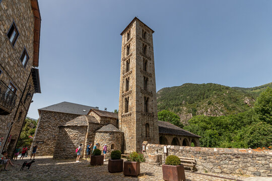 Erill la Vall, Spain. Scenic view of the eleventh century Santa Eulalia de Erill la Vall romanesque church featuring its tall lombard bell tower, stone apses and porch under a clear sky