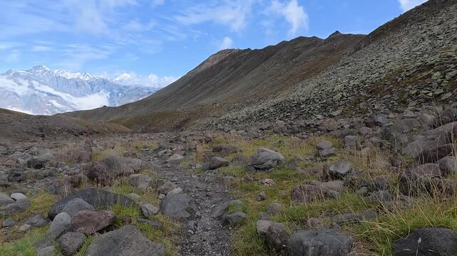 POV 4k video hiking on a rocky trail with Mount Kazbegi in the background, Georgia.