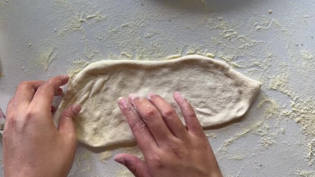 Preparation homemade pizza on kitchen table