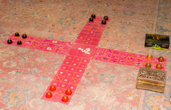 Traditional old Indian Chaupar (Chaupad) board game with a handcrafted cross-shaped cloth board. 