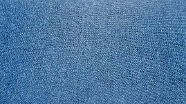 Detailed denim close-up, revealing the indigo blue texture and stitching, perfect for fashion and design projects.