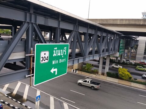 BANGKOK THAILAND 22 JUNE 2026: A green road sign indicating Route 304 leading to Min Buri on Vibhavadi Rangsit Road in Bangkok, Thailand.