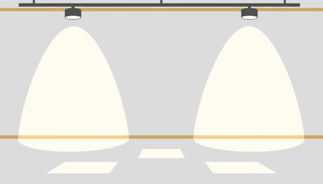 Empty exhibition wall or gallery stage illuminated by two bright ceiling spotlights with warm yellow cones of light.