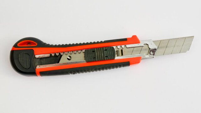 Sharp utility knife on a clear surface, ready for precise cuts for creative projects. Close-up of a stylus on a light background, an essential tool for detailed work.