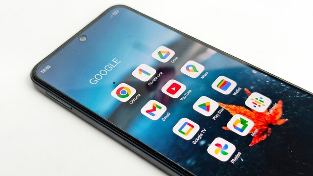 Ipoh,Malaysia - 04 July 2026: An angled close-up of a smartphone screen displaying various Google application icons, resting on a white surface.