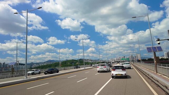 Seoul, South Korea - Jun. 26, 2026 : Driving across Seongsu Bridge over the Han River on a sunny summer afternoon in Seoul, South Korea