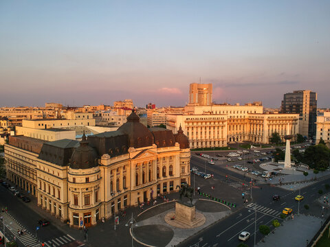 Carol i central university library and bucharest cityscape at sunset