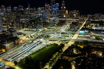 illuminated chicago skyline at night from aerial perspective with dynamic urban development and vibrant city life in usa period, with high-rise buildings, freeways, and streetlights. © 21AERIALS