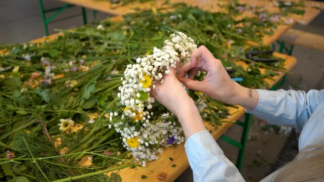 Woman making wildflower crown during floral workshop
