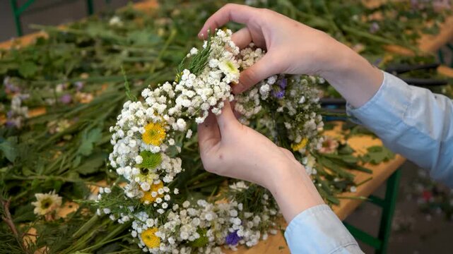 Woman making wildflower crown during floral workshop