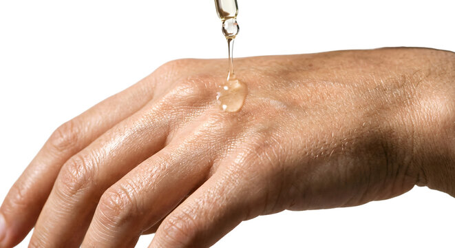 Macro of clear cosmetic oil dripping onto a bare hand glowing skin texture high visual fidelity alpha channel isolated cutout