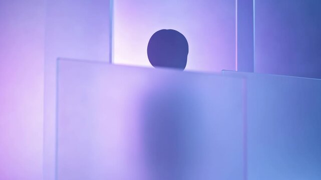 Anonymous silhouette obscured behind layers of frosted glass. Dark paper cutout figure in a purple and blue illuminated space. Data privacy and security concept