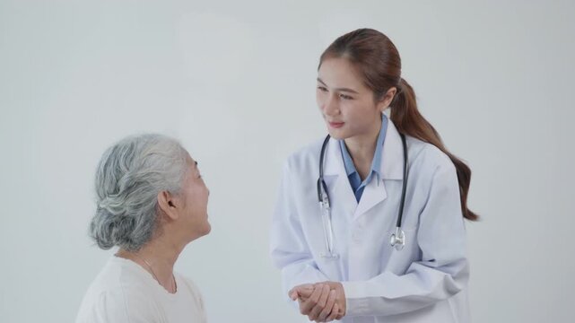 Smiling female doctor encouraging an elderly patient during a clinic visit, representing compassionate healthcare, senior care, trust, and emotional support.