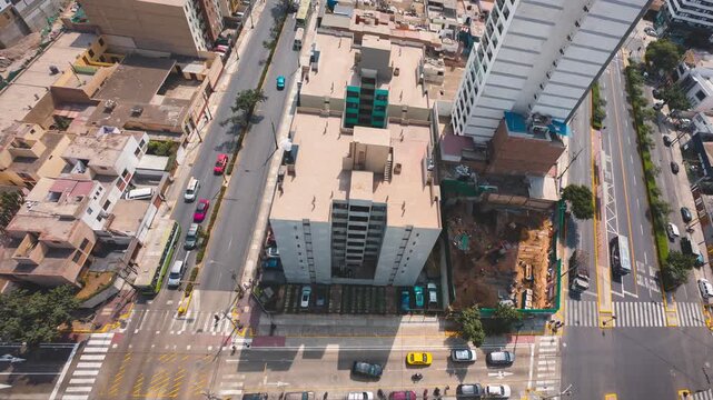 Aerial top-down timelapse showing building demolition and construction from day to night