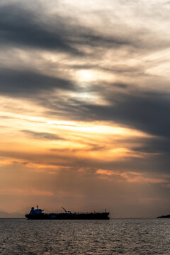 Crude oil tanker in the sea at fiery sunset. Oil and gas industry. Tankers crude oil carrier ship designed for transporting grude oil