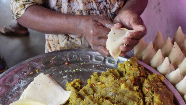 Samosa dough filling and folding traditional craft