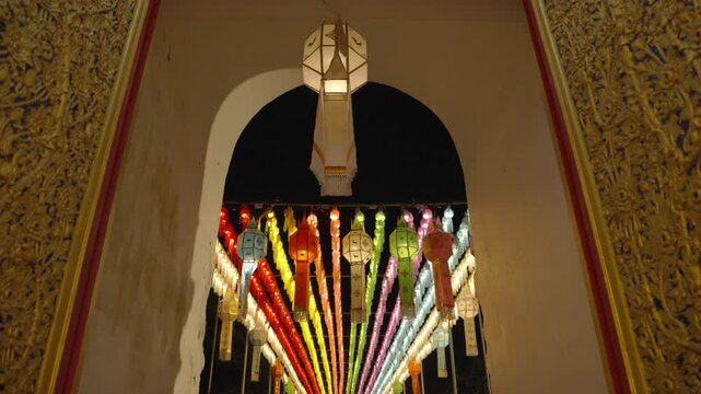 
A low-angle shot showing numerous colorful lanterns hanging at the temple's outer entrance, displayed to pay homage and demonstrate faith in Buddhism.