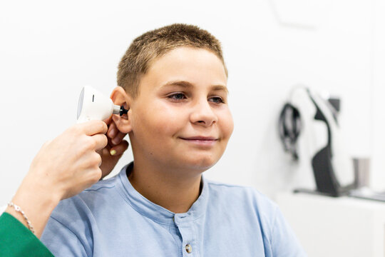 A child undergoes a hearing test with a digital otoscope at a medical center. Concept of hearing prevention in young children.