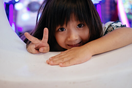 Happy little Asian girl laughing portrait