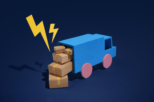 Blue toy truck overloaded with cardboard boxes and yellow