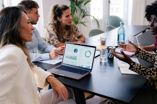 Team Discusses Project Updates at a Meeting in a Modern Office