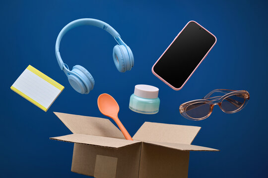 Assorted everyday objects floating out of an open cardboard