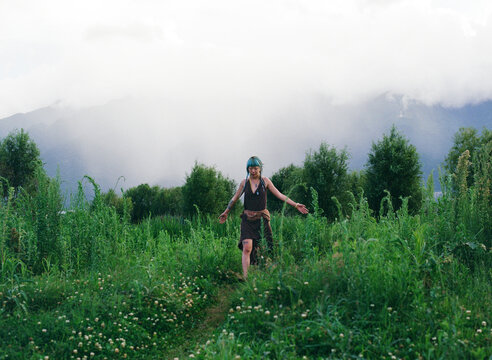 Woman with Blue Hair Walking Through Wild Field