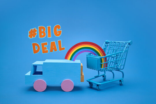Toy truck and shopping cart with rainbow and #BIG DEAL text