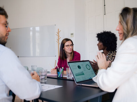Group Discusses Business Strategy in Office Meeting Room